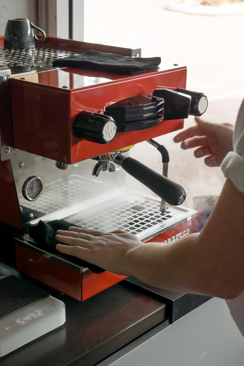 Espresso machine and grinder on a workshop bench