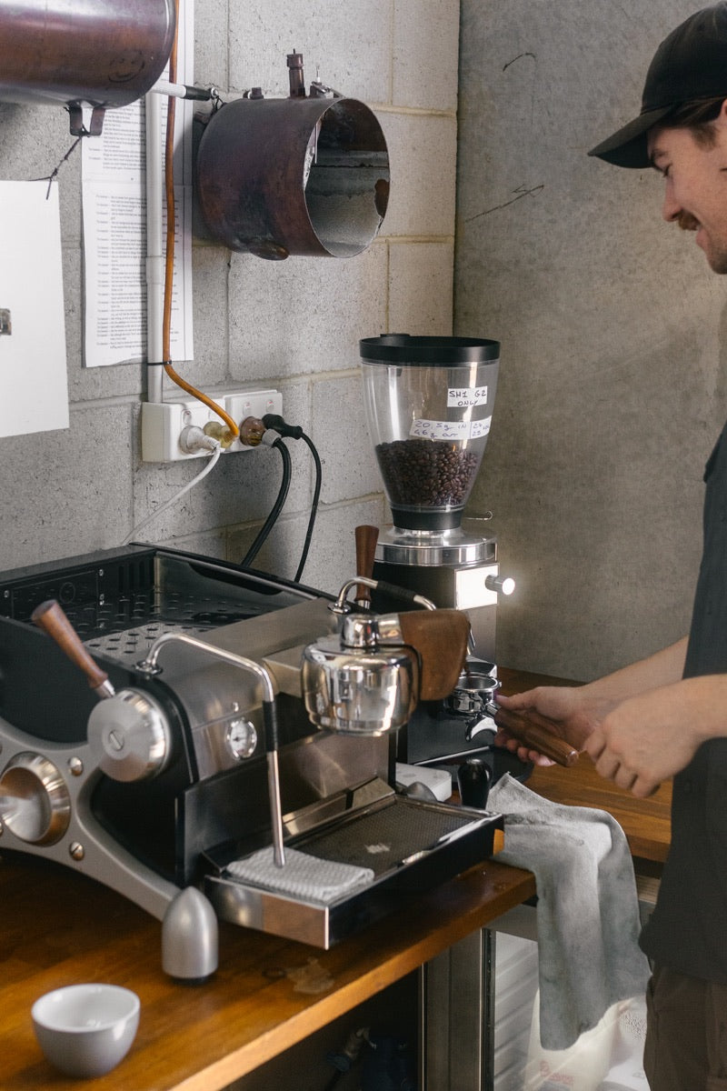 Espresso machine and grinder on a workshop bench
